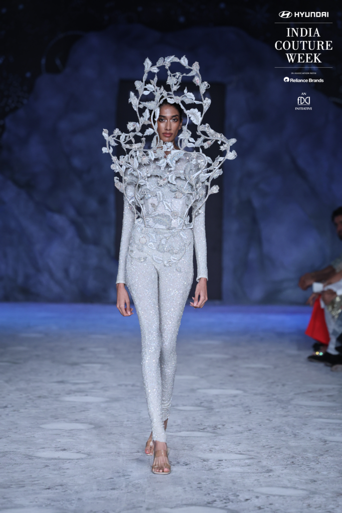 Model in sculptural silver bodysuit with 3D floral cage by Rahul Mishra at India Couture Week 2025