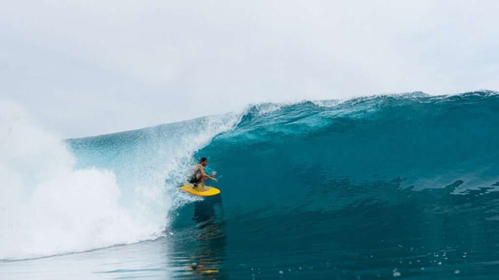 Surfer riding a perfect wave in the Maldives during the Four Seasons Surfing Champions Trophy 2025