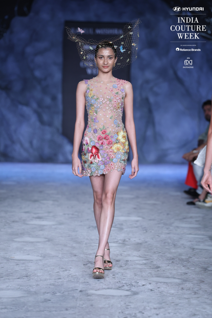 Model in a floral embroidered mini dress with galaxy headpiece by Rahul Mishra at ICW 2025