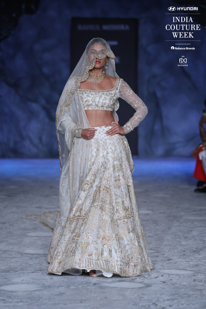 Model in ivory embroidered bridal lehenga with veil by Rahul Mishra at ICW 2025