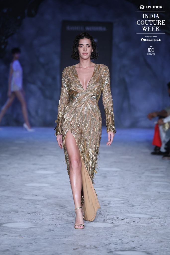 Model in a gold sequin slit gown by Rahul Mishra at India Couture Week 2025